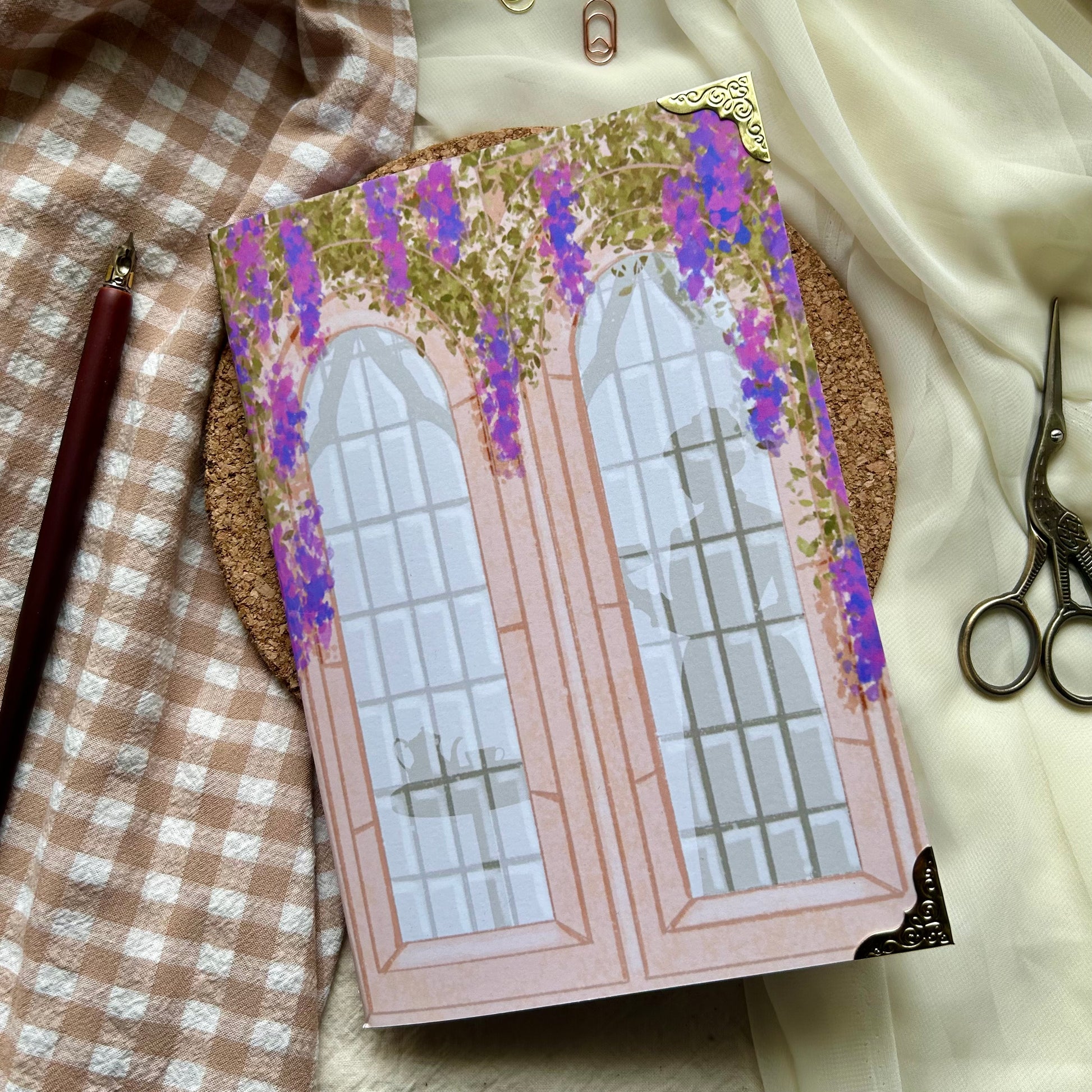 Regency themed notebook, illustration of 2 long windows surrounded by wisteria and a silhouette of a woman drinking tea.